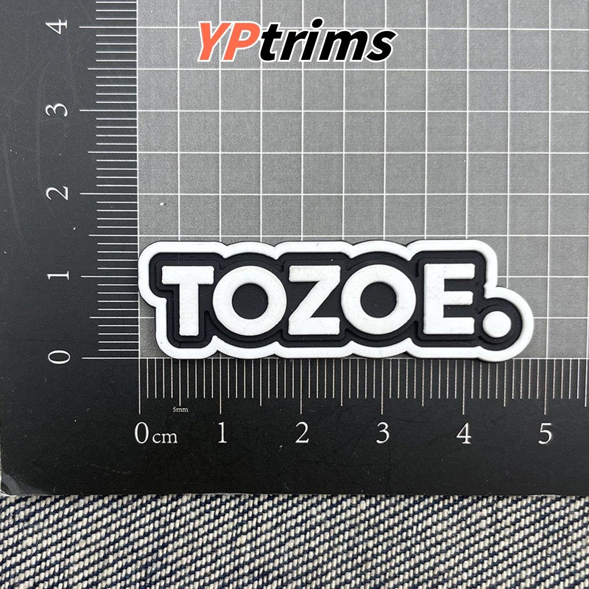 custom grey reflective embossed round leather patch for jackets, pants & bags – garment label factory