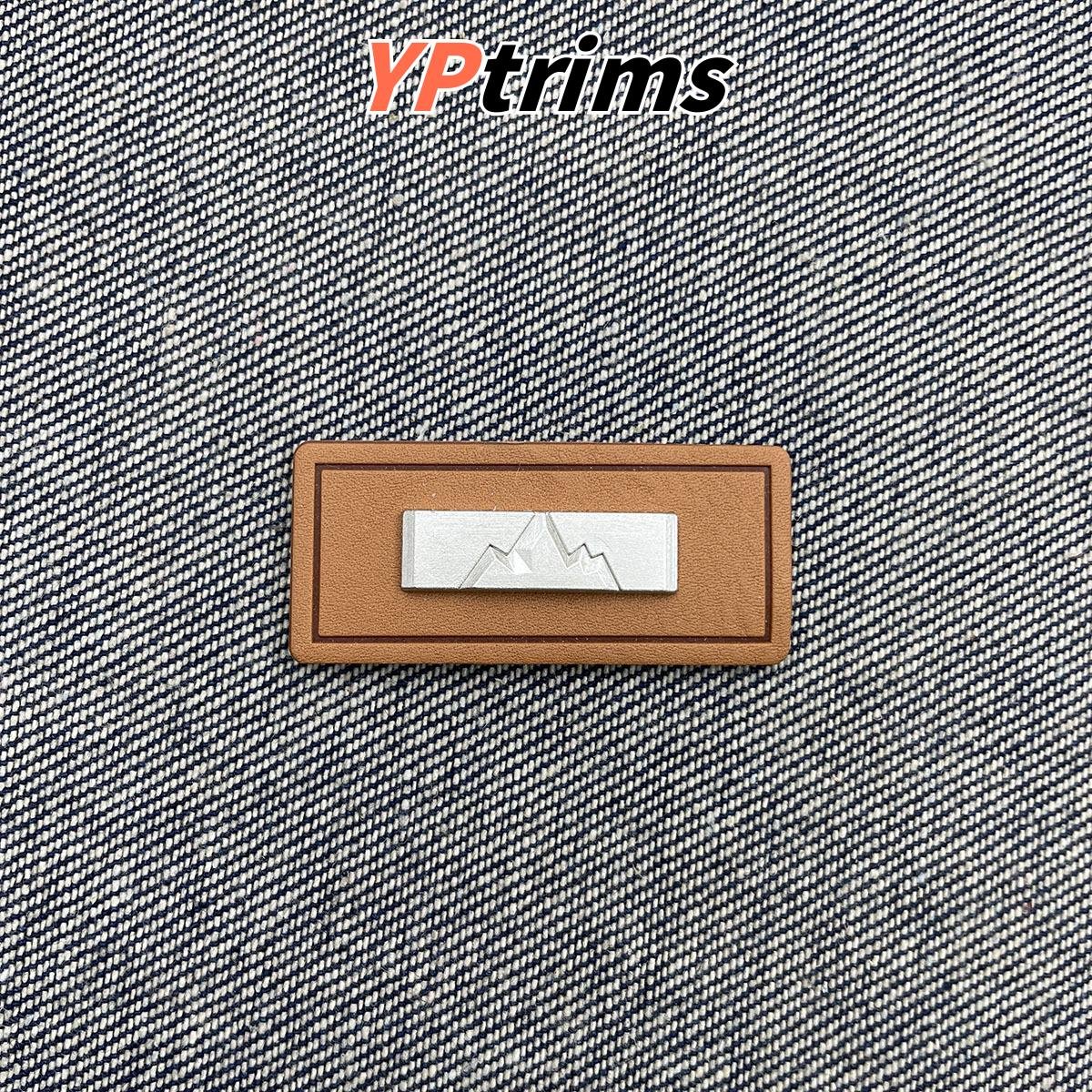 wholesale mountain pattern leather tag with metal decoration – outdoor fashion garment label | supplier
