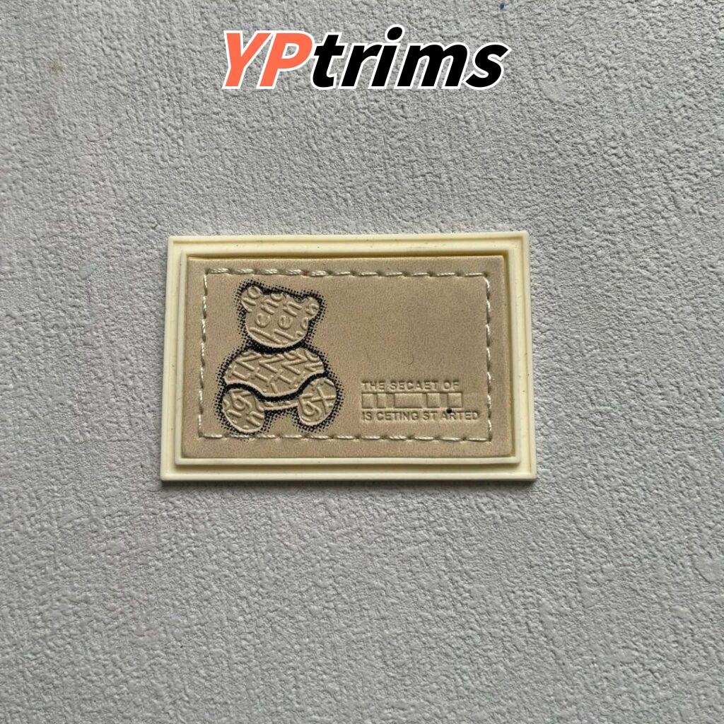 custom rectangular pvc little bear pattern sewn combination leather label for trendy pet and kids' clothing